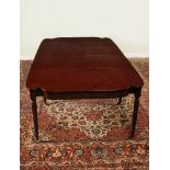 A George III plum pudding mahogany extending dining table, circa 1810, with three additional leaf