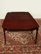 A George III plum pudding mahogany extending dining table, circa 1810, with three additional leaf
