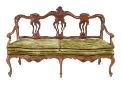 An Italian carved walnut chair back settee, mid 18th century, the carved and moulded back