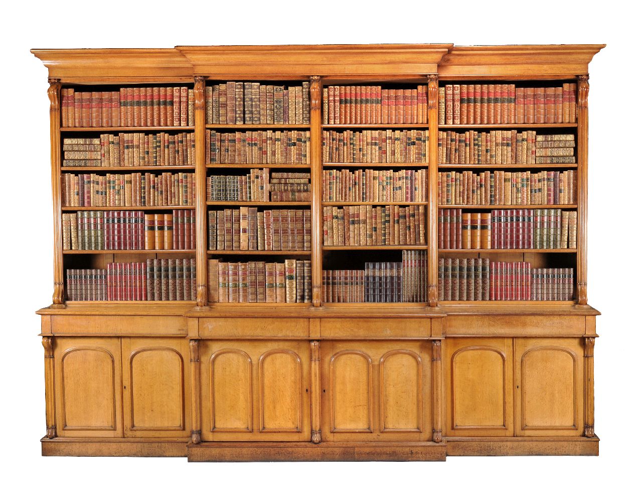 A large Victorian oak breakfront library bookcase, circ 1860, the moulded cornice above four banks
