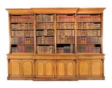A large Victorian oak breakfront library bookcase, circ 1860, the moulded cornice above four banks