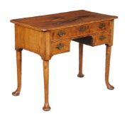 A George II walnut side table, circa 1735, the rectangular quarter veneered top with cross banded
