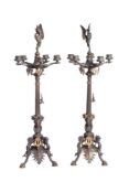 A pair of French patinated and gilt bronze five light candelabra in Neoclassical style, circa