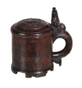 A Scandinavian carved and stained birch peg tankard, late 18th century, of cylindrical form, the