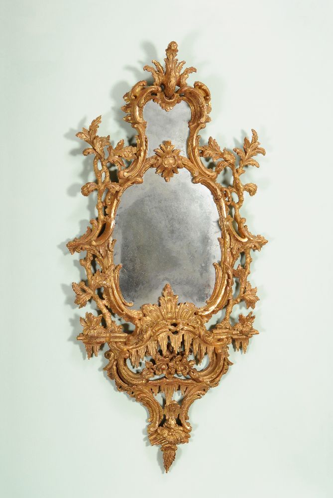 A carved giltwood and gesso wall mirror, late 18th/19th century, the central shaped plate within a