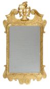 A George I giltwood and gesso wall mirror, circa 1720, the rectangular plate within a moulded border