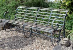 A Victorian painted wrought iron garden seat, last quarter 19th century, of slatted construction,