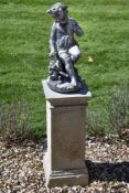 A sculpted lead model of a seated putto, late 19th / early 20th century, portrayed as lightly