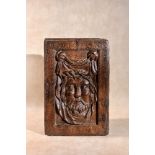 A sculpted oak panel depicting the face of Christ on the Veil of Saint Veronica, 16th century, of