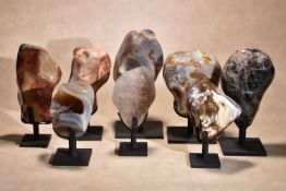 Eight various polished freeform mineral specimens, with bespoke wrought iron stands, including