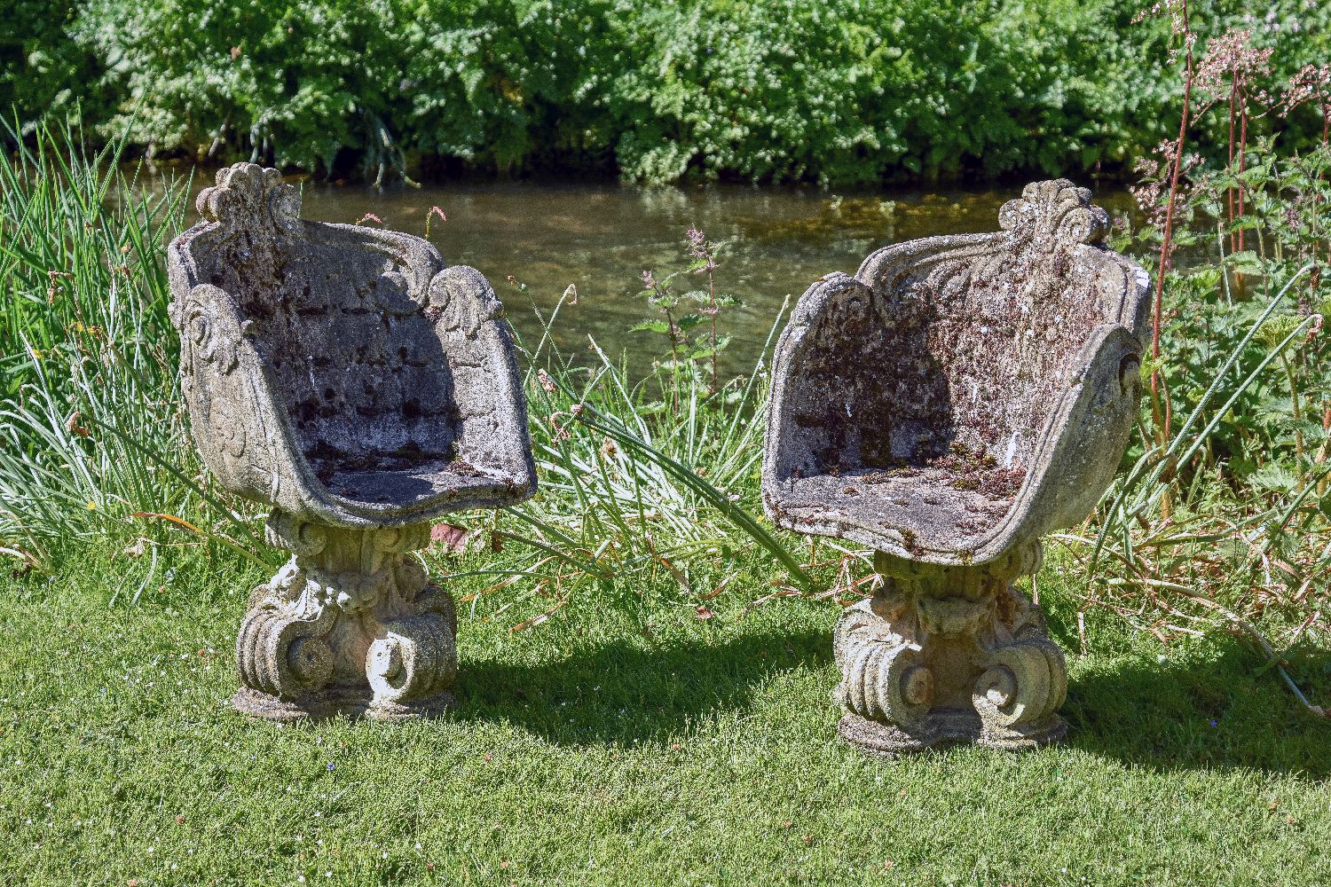 A pair of stone composition garden tub chairs in Baroque style, second half 20th century, each