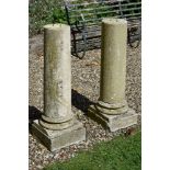 A pair of stone composition columnar pedestals, 20th century, with moulded socles and square