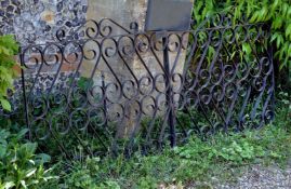 A pair of painted wrought iron gates, early 20th century, of rectangular form, with openwork