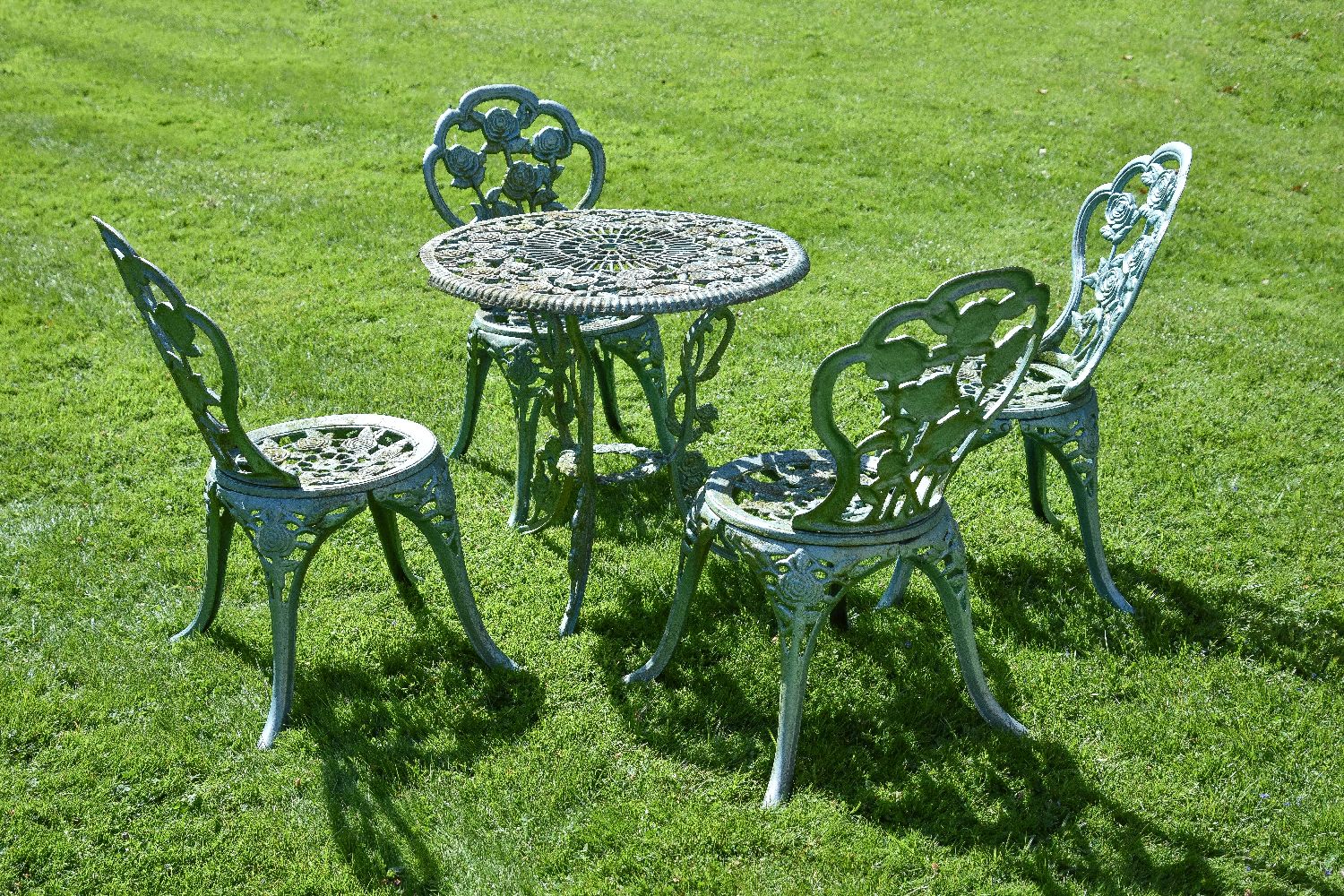 A pair of painted cast iron garden tables and two sets of four chairs en suite, mid 20th century, - Image 2 of 3