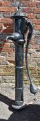 A Victorian cast iron water pump, late 19th century, the fluted and domed top with urn finial, above