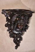 A carved and stained hardwood wall bracket, in Roccoco style, second half 19th century, the shaped