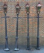 A set of four cast and painted aluminium lamp posts, late 20th century, each with a glazed and