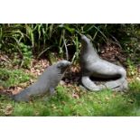 A pair of composition garden models of seals, mid 20th century, naturalistically modelled, with