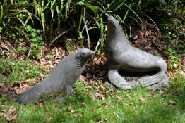 A pair of composition garden models of seals, mid 20th century, naturalistically modelled, with