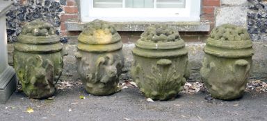 A set of four substantial sculpted limestone pier finials, late 17th/early 18th century, the piled