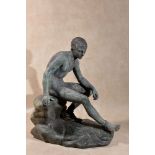 An Italian verdigris patinated bronze and green serpentine marble mounted model of the Seated