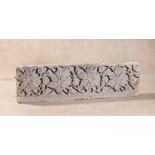 A French relief sculpted limestone frieze panel, early 16th century, carved with four blooms