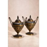 A pair of Continental parcel gilt and patinated bronze twin handled urns and covers in