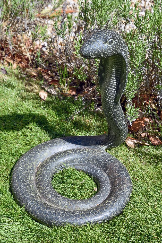 A sculpted stone model of a cobra, second half 20th century, portrayed rising from its coiled body