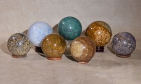 A group of seven assorted polished hardstone mineral specimen spheres, comprising one of chrysacola,