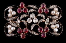 An Art Nouveau diamond, ruby and pearl brooch, circa 1905, the pierced scrolled foliate panel with