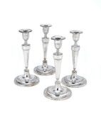 A set of four George III silver circular candlesticks by Samuel Roberts & Co., Sheffield 1781, the