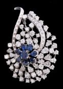 A sapphire and diamond spray brooch, set with a flower head of pear cut sapphires centred around