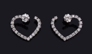A pair of diamond heart earrings by Massoni, the heart shaped earrings set with brilliant cut