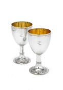 A pair of George III silver goblets probably by John King, London 1773, with a threaded rim, plain