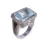 An aquamarine and diamond ring, the rectangular cut aquamarine in a four claw setting, within a