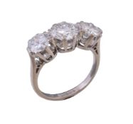 A three stone diamond ring, the central brilliant cut diamond weighing 1.31 carats, flanked by two