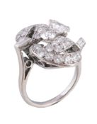 A 1950s diamond dress ring, the crossover pavé set brilliant cut diamond leaves with baguette cut
