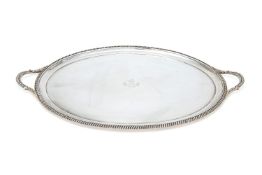 An Edwardian silver oval twin handled tray by D. & J. Wellby, London 1909, with gadrooned and