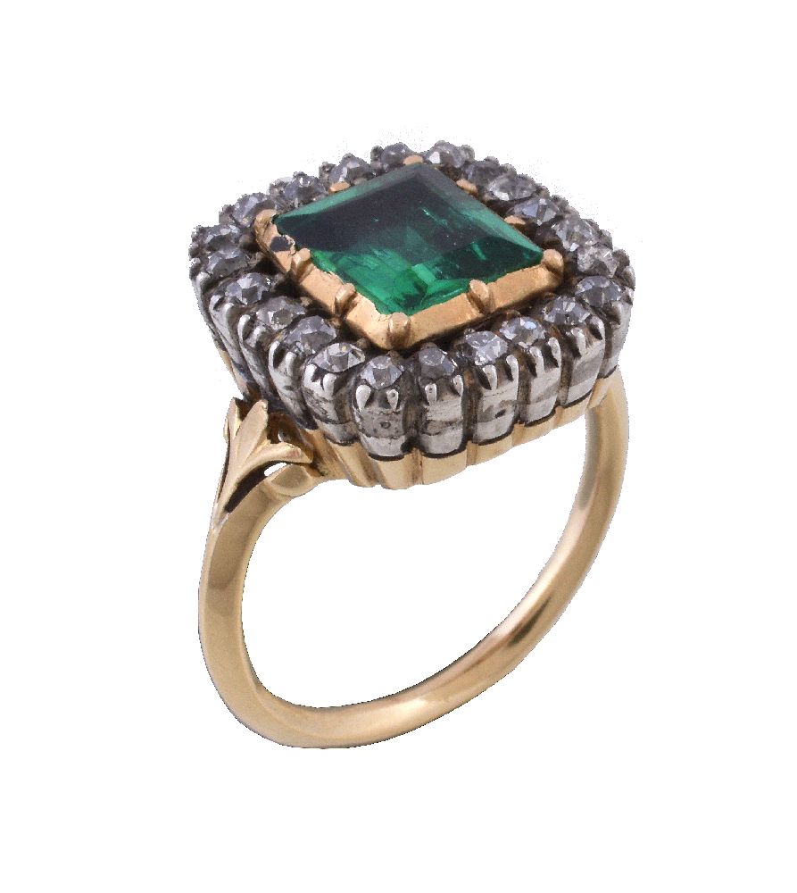 An antique emerald and diamond cluster ring, the step cut emerald within a cut down collet closed
