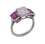 A 1930s diamond and ruby three stone ring, the asscher cut diamond weighing 2.18 carats in a four