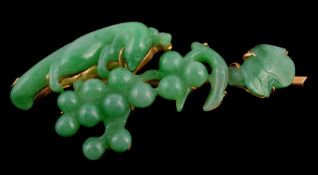 A green jadeite brooch, the brooch with a carved polished squirrel upon a grape vine, the gold