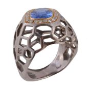 A sapphire and diamond cluster dress ring, the the oval cut sapphire estimated to weigh 2.25 carats,