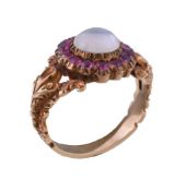 An early Victorian moonstone and ruby cluster ring, circa 1850, the central circular cabochon