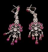 A pair of ruby and diamond ear pendants, the pierced scrolled panels set with brilliant cut diamonds