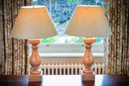 A pair of turned walnut table lamps, of baluster form, 48cm high excluding fitments, 81cm high