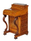A Victorian walnut Davenport, circa 1870, with rising piano top enclosing drawers and pigeonholes,