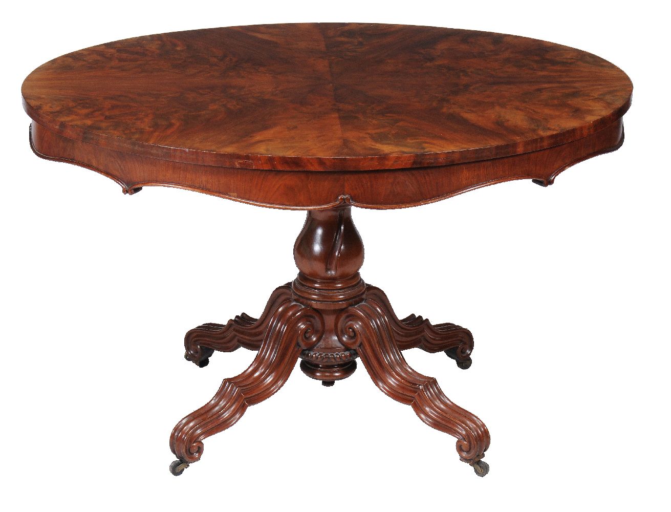 A Victorian mahogany oval centre table, circa 1870, the radial veneered top above carved and