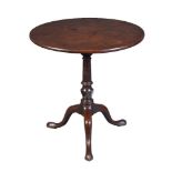 A George III mahogany tilt top table, circa 1780, with single plank top and a wrtyhen vase, 70cm