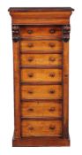 A Victorian mahogany Wellington chest, circa 1860, with arrangement of seven drawers retained by a