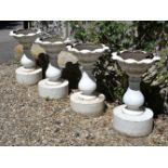 A set of four cast iron garden urns, in the manner of examples by Andrew Handyside and co. of Derby,